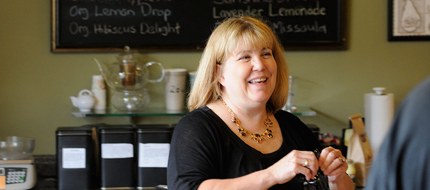 Danielle Beaudette smiling at a customer in the shop.