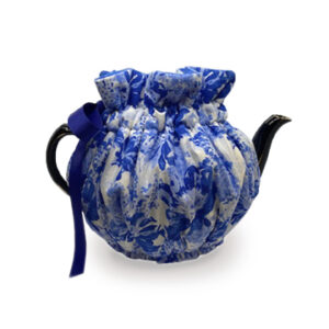 Wrapping tea cozy with Tranquil Blossoms pattern on fabric; shades of blue.